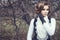 Gorgeous young woman with elegant Victorian hairstyle holding her hand in leather glove at her cheek