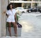 Gorgeous young woman poses in city wearing white romper