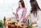 Gorgeous young Women preparing dinner in a kitchen