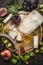 Gorgonzola and Camembert cheese with Knife for cheese white and dark grapes, honey and jam on wooden cutting board on a dark ru