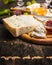 Gorgonzola Camembert on a wooden cutting board with a knife for cheese with honey and jam light grape on dark wooden background cl