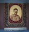 Gori Georgia - Oriental rug  with Joseph Stalins portrait hangs in town of his birthplace with blue rug on wall and