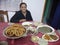 A gorkhali woman with yummy traditional dishes prepared by her