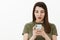 Gosh you never gues what posted online. Portrait of impressed and speechless girl using smartphone looking amazed and