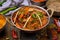 Gosht masala indian food in a copper on blue wooden table