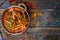 Gosht masala indian food in a copper on blue wooden table top view with copy space
