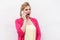 Gossip girl! Portrait of exited young woman in pink blouse standing, using and making call on her smartphone with wondering face