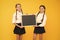 Got ready. Small pupils. Small girls holding blackboard on yellow background. Small schoolchildren with black-board for