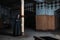 Gothic brunette woman stands leaning against a pillar in large empty hall