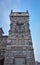 Gothic castle, outside view, against the sky, tower with a window in the form of a spider