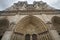 Gothic cathedral in West Portals Facade of Notre Dame, France, historic monuments detail ancient statue art outside