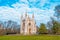 Gothic church in an autumn park with a picturesque blue sky.