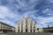 The gothic Duomo Cathedral facade in Milan, Italy on a beautiful spring day.