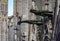 Gothic gargoyles covered with moss on the facade of famous Notre Dame de Paris Cathedral in Paris France with rain drops falling