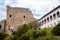 Gothic medieval castle Velhartice, sunny day, white mansion, facade with arches, masonry wall, old stronghold with tower,