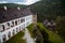 Gothic medieval castle Velhartice, sunny day, white mansion, facade with arches, masonry wall, old stronghold with tower,