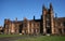 Gothic revival style facade of classic and historic Quadrangle with beige sandstone at University of Sydney, Australia