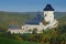 Gothic royal castle Karlstejn in green forest window during autumn, Central Bohemia, Czech republic, Europe