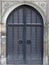 Gothic style arch wooden door and stone wall
