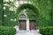 Gothic style building entrance, covered in ivy