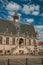 Gothic-style building of the town hall and people in the central square of Damme.