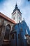 Gothic style ornate window and gray brick wall of the church. Medieval architecture in Europe. Tallinn old town details.