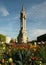 Gothic tower in a square with flowers in Paris