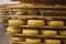 Gouda cheese wheels on shelves