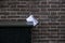Gouda, South Holland/The Netherlands - February 15 2020: white open envelop jammed between a brick wall and a dark colored