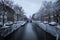 Gouda, South Holland/The Netherlands - February 7 2021: A view on a winter city landscape from a bridge over the canals in the