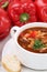 Goulash soup with meat, baguette and paprika closeup