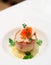 Gourmet appetizer with artichoke, seafood, and salmon roe