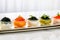 Gourmet appetizers with red and black caviar, served in elegant glassware on white table