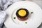Gourmet beefsteak Tatar with lean raw beef filet, capers, egg yolk, onions, toast bread, black caviar on porcelain plate on light