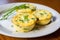 Gourmet breakfast: homemade egg muffin cups with cheese and greens on a plate