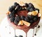 A gourmet cake drenched in chocolate and garnished with blackberries and figs. Holiday sweets.