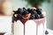 A gourmet cake drenched in chocolate and garnished with blackberries and figs. Holiday sweets.