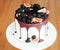 A gourmet cake drenched in chocolate and garnished with blackberries and figs. Holiday sweets.