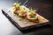 gourmet caprese with microgreens and glaze on a slate plate
