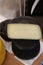 Gourmet cheese. Yellow goat cheese and cheese in a sepia ink wrap. Delicatessen cheeses. Delicious cheese. Farm made organic.
