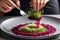 Gourmet Chef Plating an Intricate Dish: Arranging a Delicate Microgreen Salad Atop a Spiral of Ruby Elegance