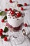 Gourmet cherry dessert in a glass close-up on the table. vertical