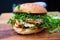 Gourmet Chicken Burger Featuring Onions and Fresh Arugula.