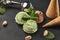 Gourmet chocolate and pistachio ice cream served on a stone slate over a black background.