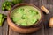 Gourmet cream of broccoli green soup in wooden