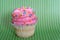 Gourmet cupcake on green background