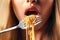 Gourmet delight: close up of woman\\\'s mouth savoring Italian spaghetti