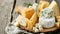 Gourmet Delights: Exploring the Delectable Varieties of Cheeses on a Wooden Platter