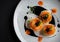 Gourmet dessert with orange slices and black caviar