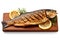 Gourmet food composition grilled and smoked striped bass on rustic wooden board.